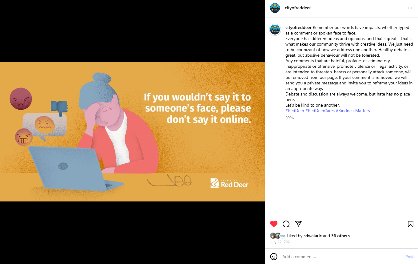 A screenshot of a City of Red Deer Instagram post featuring an illustrated graphic on a mustard‑yellow background. The illustration shows a person seated at a laptop, with reaction icons and comment symbols hovering near the screen. Large white text reads, “If you wouldn’t say it to someone’s face, please don’t say it online.” The City of Red Deer logo appears in the bottom right corner. The post caption references the importance of respectful language and outlines moderation guidelines.
